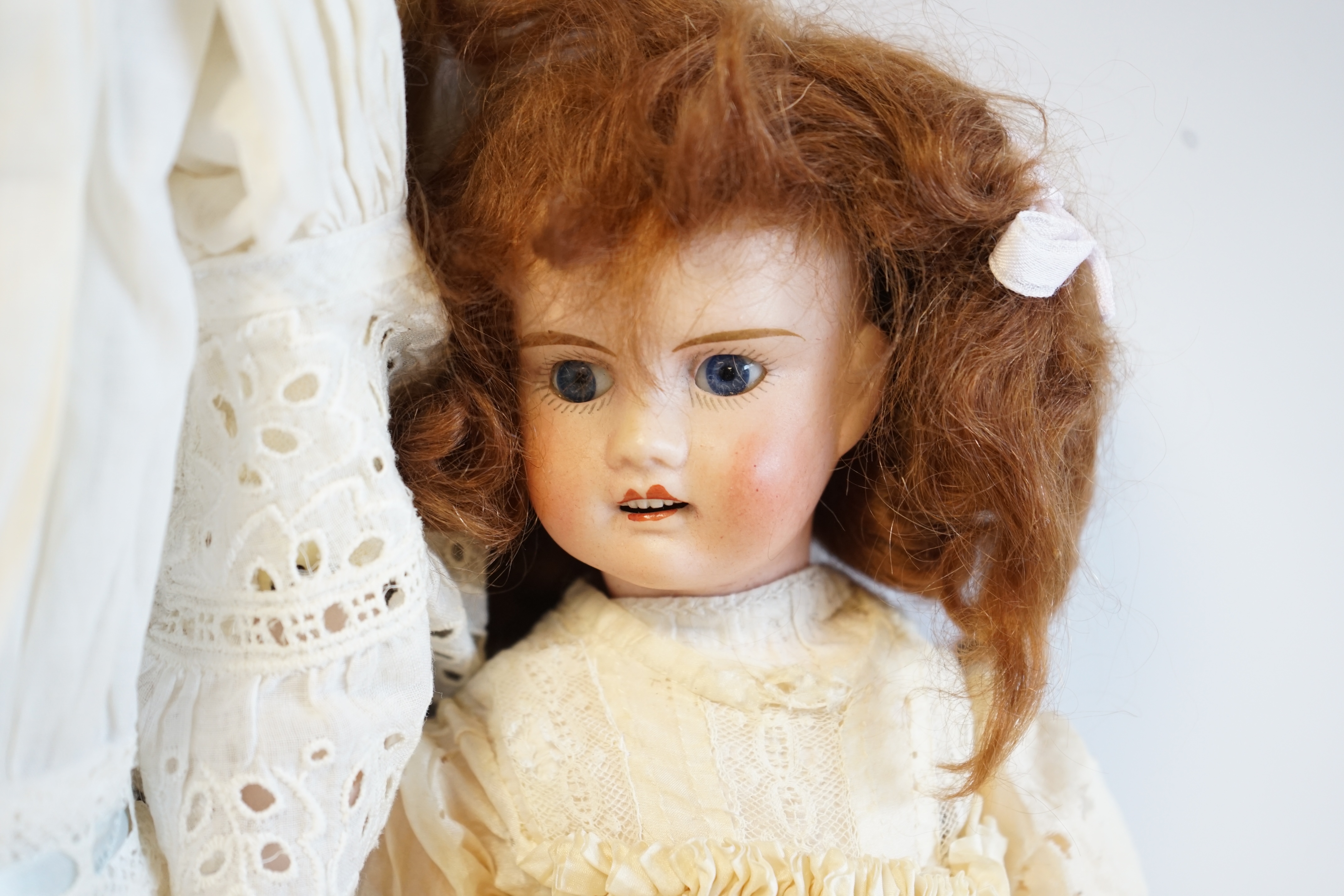 A German bisque shoulder plate doll marked bb on kid body, 60cm high, together with an SFBJ60, 42cm, and a Unis France, 36cm high (3). Condition - good